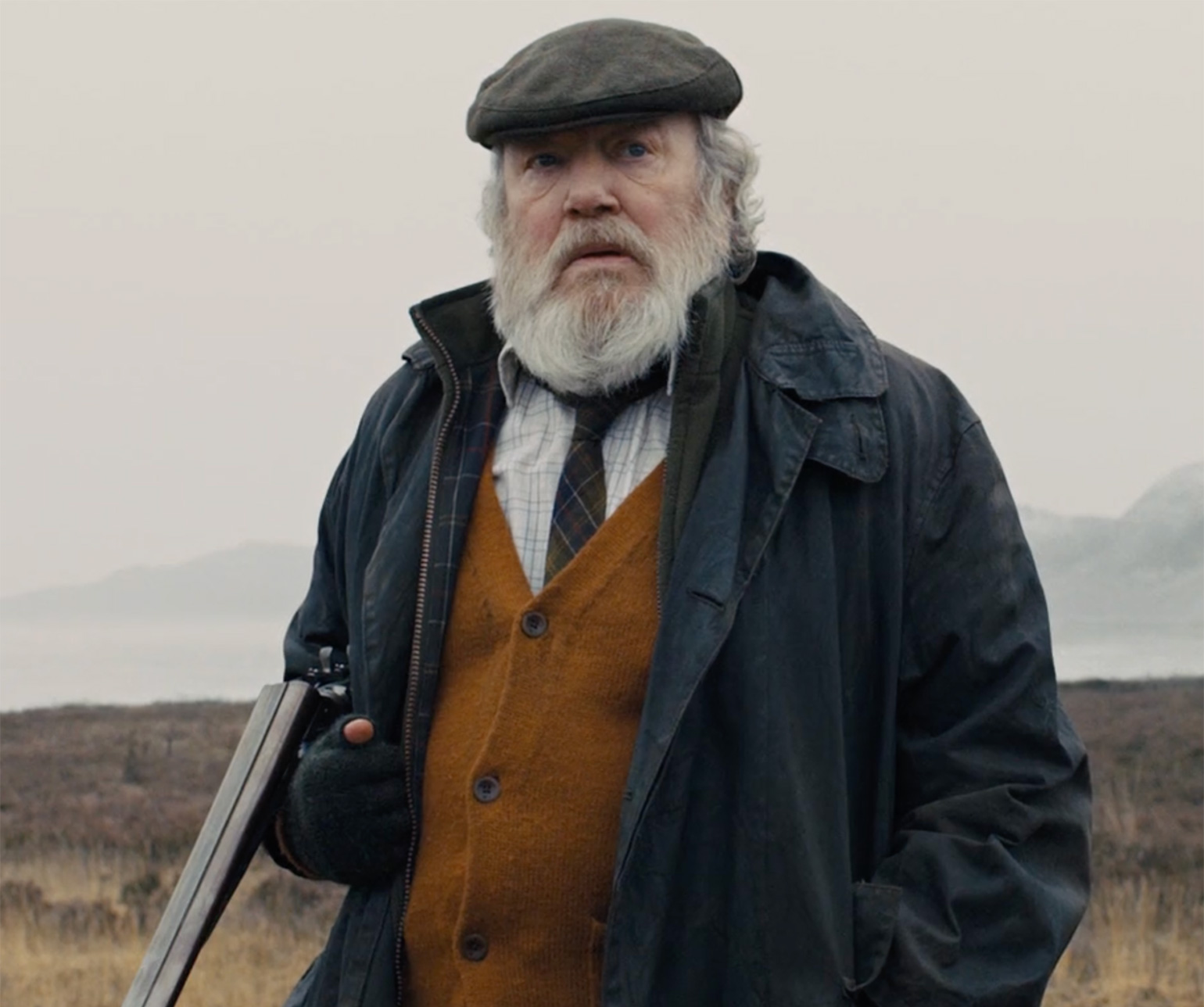 Albert Finney as Kincade in SkyFall, wearing a Cordings cap.