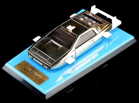 Gold plated Lotus Esprit scale model Corgi auction blue plate base