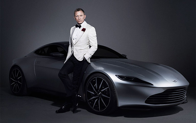 photo © Danjaq, MGM Daniel Craig as James Bond poses with the Aston Martin DB10