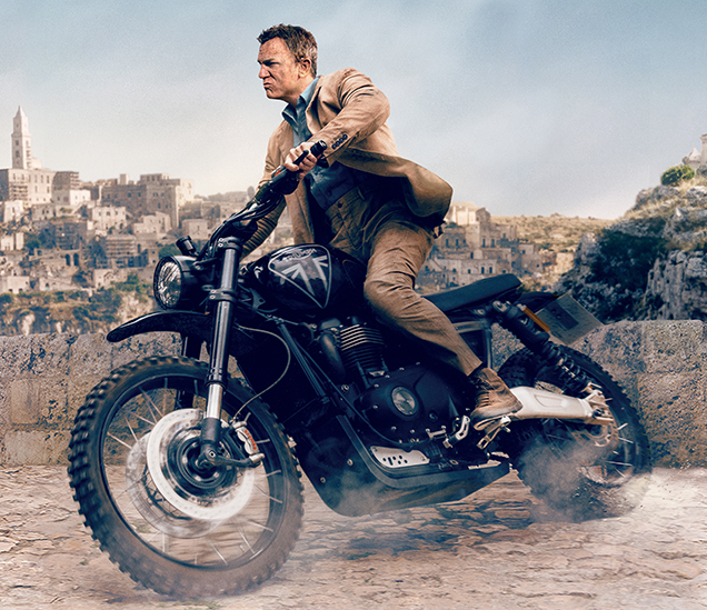 photo © Danjaq LLC, MGM, United Artists Daniel Craig as James Bond on a Triumph Scrambler 1200 XE