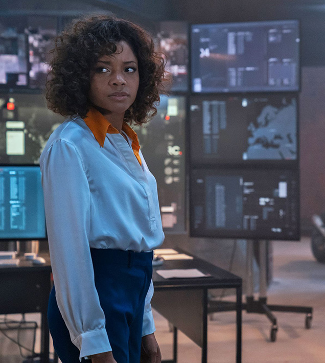 photo © Danjaq LLC, MGM, United Artists Eve Moneypenny (Naomie Harris) wears a white Equipment Margery Washed Silk-blend shirt in No Time To Die.