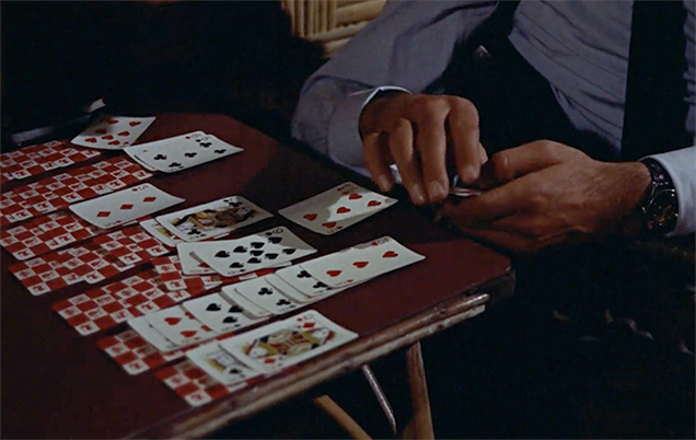 photo © Danjaq LLC, United Artists James Bond plays patience with Waddingtons Zodiac cards in Miss Taro's bedroom.