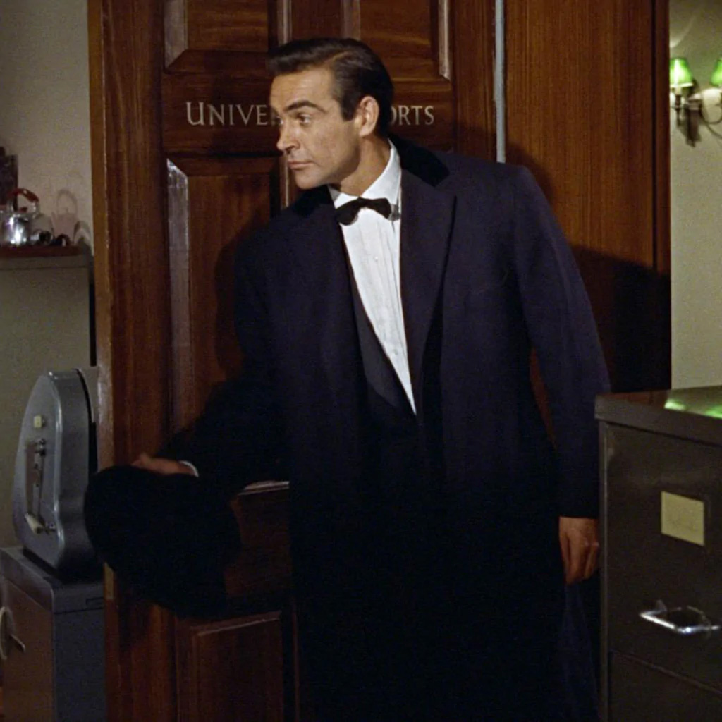 photo © Danjaq LLC, United Artists Sean Connery in the first movie Dr. No wearing the Anthony Sinclair Navy Chesterfield Overcoat